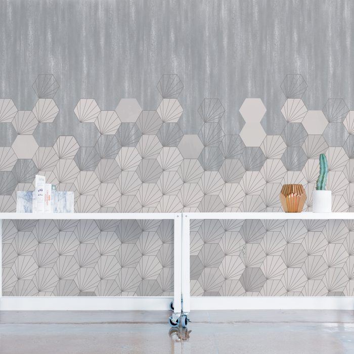 white concrete tiles geometric design set against a concrete background. Custom digitally printed wallcovering for commercial interiors.