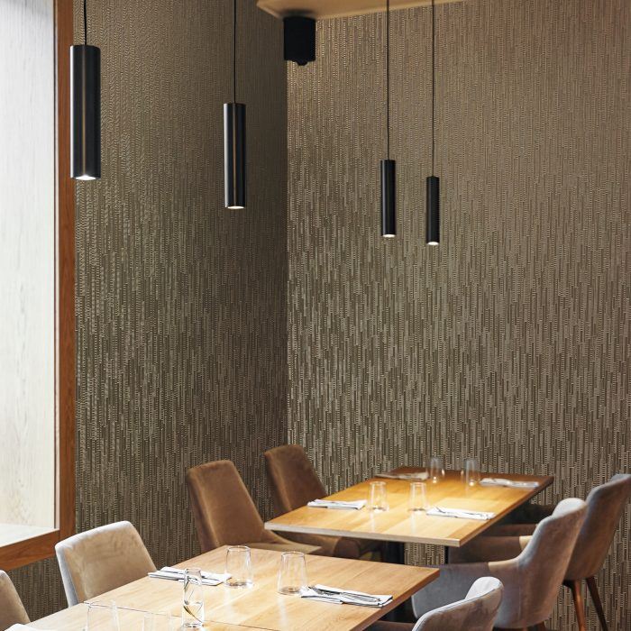 metallic wallcovering with deeply textured vertical stacked blocks which catch the light from every angle in a hospitality interior